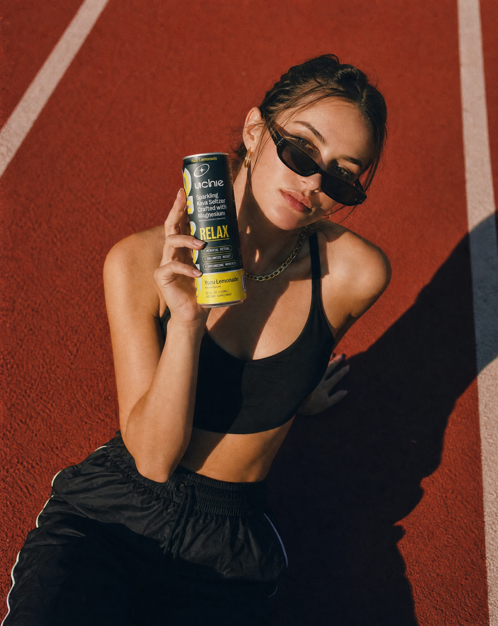 Someone unwinding at golden hour with a can of Uchie Relax